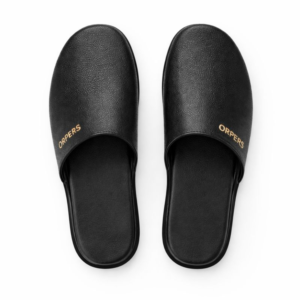 Top view of black ORPERS slip-on slippers with textured finish and gold logo detailing.