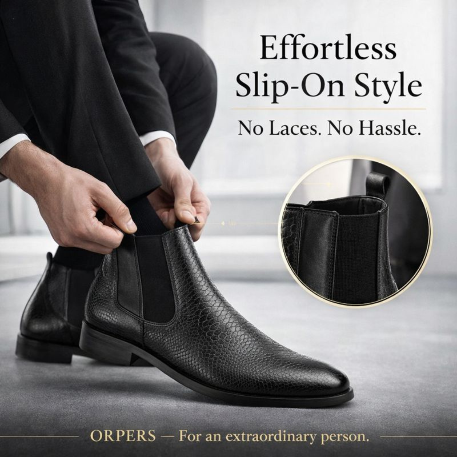 Man wearing ORPERS black textured leather Chelsea boots, easily slipping them on using the elastic side panels in a formal indoor setting.